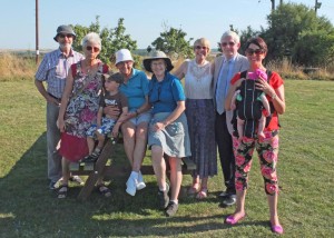 Irené - in the white hat - surrounded by family. Four generations in this photo!